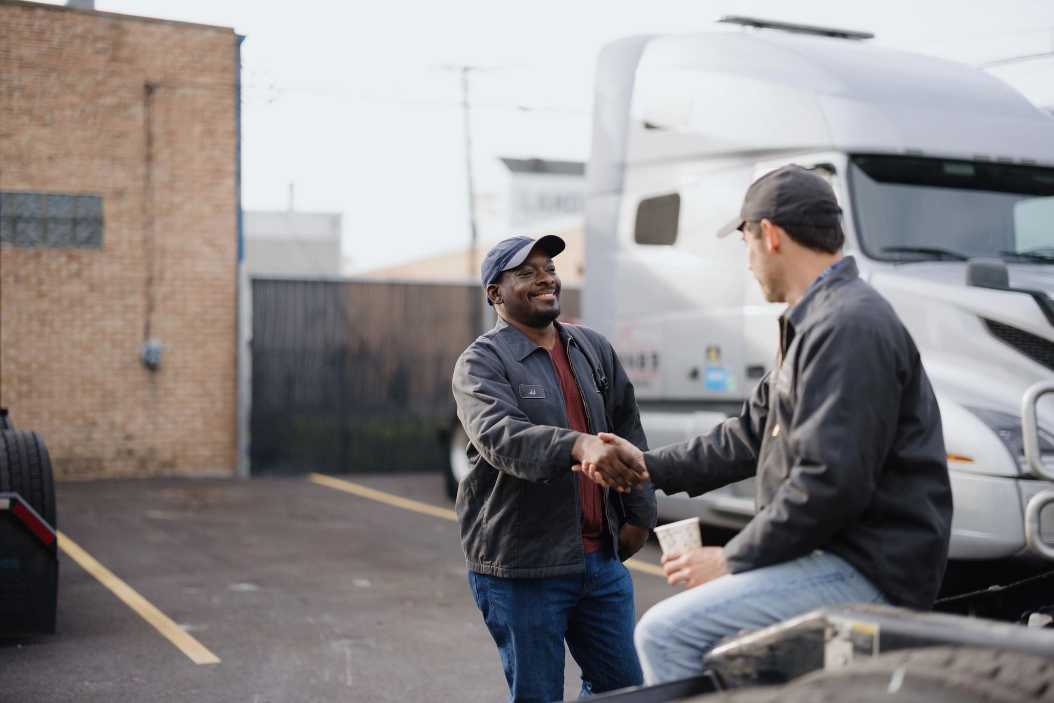 Two professionals shaking hands representing procurement partnership